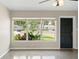 Bright living room with polished floors, a ceiling fan and view of landscaping through the multi-pane front window at 5961 41St N Ave, St Petersburg, FL 33709