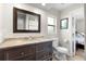 Well decorated bathroom with wood vanity, granite countertop, and dark wood framed mirror at 6006 114Th N Ter, Pinellas Park, FL 33782