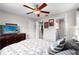Serene bedroom with a comfortable bed, ceiling fan, and convenient access to closet and ensuite bathroom at 6006 114Th N Ter, Pinellas Park, FL 33782