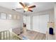 Bedroom features wood floors, a ceiling fan and a white closet at 6006 114Th N Ter, Pinellas Park, FL 33782