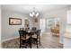 Dining room boasts wood floors, two dining tables and views of the backyard at 6006 114Th N Ter, Pinellas Park, FL 33782