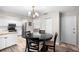 Dining room with round wood table and seating for four adjacent to the kitchen at 6006 114Th N Ter, Pinellas Park, FL 33782