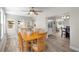 Dining room with wood floors, wood table, and views into other rooms at 6006 114Th N Ter, Pinellas Park, FL 33782