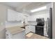 Kitchen with granite counters, stainless steel appliances, and white cabinets at 6006 114Th N Ter, Pinellas Park, FL 33782