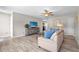 Bright living room featuring wood-look flooring, comfortable furniture, a ceiling fan, and lots of natural light at 6006 114Th N Ter, Pinellas Park, FL 33782