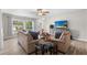Spacious living room with stylish furniture, wood-look floors, and a ceiling fan providing ample comfort at 6006 114Th N Ter, Pinellas Park, FL 33782