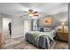 Comfortable bedroom features wood floors, ceiling fan, and en-suite bathroom with walk-in closet at 6006 114Th N Ter, Pinellas Park, FL 33782