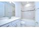 Well lit bathroom with a bathtub/shower and vanity with granite countertop at 6119 Bradford Woods Dr, Zephyrhills, FL 33542
