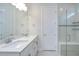 Bathroom featuring a double vanity, quartz countertop and shower with glass door at 6119 Bradford Woods Dr, Zephyrhills, FL 33542