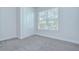 Bedroom with a window letting in natural light and a double door closet at 6119 Bradford Woods Dr, Zephyrhills, FL 33542