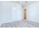 Bedroom featuring a double door closet with open door leading to a hallway at 6119 Bradford Woods Dr, Zephyrhills, FL 33542
