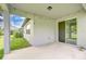 Covered patio with string lights leading to a sliding glass door and view of fenced backyard at 6119 Bradford Woods Dr, Zephyrhills, FL 33542