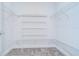 A well-organized walk-in closet with wire shelving and gray carpet at 6119 Bradford Woods Dr, Zephyrhills, FL 33542
