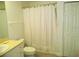 Clean bathroom with a tub and shower combination, white vanity, and tile flooring at 6714 Dali Ave # 102, Land O Lakes, FL 34637