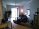Inviting living room with neutral colors, tile floors, and sliding glass doors offering scenic views at 6714 Dali Ave # 102, Land O Lakes, FL 34637