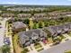 An aerial view highlights a residential neighborhood with lush green spaces and well-maintained landscaping at 6924 Towne Lake Rd, Riverview, FL 33578