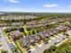 An aerial view showcases a residential neighborhood with a serene lake and lush greenery at 6924 Towne Lake Rd, Riverview, FL 33578