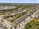 An aerial view shows a neighborhood featuring a tranquil lake and lush, green spaces at 6924 Towne Lake Rd, Riverview, FL 33578