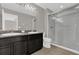 This bathroom features a double sink vanity, shower, and tile flooring at 6924 Towne Lake Rd, Riverview, FL 33578