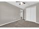 This is a bedroom featuring carpeted floor, ceiling fan, and closet at 6924 Towne Lake Rd, Riverview, FL 33578