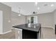 Open Kitchen with black granite island and tiled floors leading to sliding door to patio at 6924 Towne Lake Rd, Riverview, FL 33578