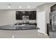This is a spacious kitchen with dark cabinets, granite countertops, and stainless steel appliances at 6924 Towne Lake Rd, Riverview, FL 33578