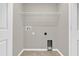 A practical laundry room features tile flooring and essential hookups, ready for modern appliances at 6924 Towne Lake Rd, Riverview, FL 33578