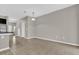 Open living room and kitchen area with stairs, neutral walls, and tiled flooring at 6924 Towne Lake Rd, Riverview, FL 33578