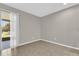 Empty living room with tiled floor, neutral walls and sliding door leading to outside patio at 6924 Towne Lake Rd, Riverview, FL 33578