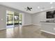 Open floor plan featuring living room with ceiling fan and sliding door leading to patio at 6924 Towne Lake Rd, Riverview, FL 33578