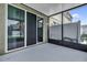 View of a screened patio with seamless sliding doors offering a perfect spot for relaxation at 6924 Towne Lake Rd, Riverview, FL 33578