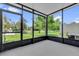 An enclosed patio provides an airy space with a view of the well-maintained green grounds at 6924 Towne Lake Rd, Riverview, FL 33578