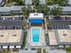 Aerial view of community pool surrounded by lounge chairs and neatly organized parking lots at 6960 Sunset S Dr # 2B, South Pasadena, FL 33707