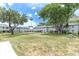 Well-maintained grassy courtyard featuring a gazebo, mature trees, and seating areas for residents at 6960 Sunset S Dr # 2B, South Pasadena, FL 33707