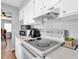 Functional kitchen featuring sleek appliances, white cabinetry, and plenty of counter space at 6960 Sunset S Dr # 2B, South Pasadena, FL 33707