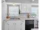 Bright kitchen with white cabinets, stainless steel sink, and a convenient dishwasher at 6960 Sunset S Dr # 2B, South Pasadena, FL 33707