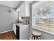 Bright kitchen with white cabinets, stainless steel sink, and a view from the large window at 6960 Sunset S Dr # 2B, South Pasadena, FL 33707