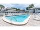 Inviting community pool surrounded by lounge chairs and manicured landscaping providing a relaxing atmosphere at 6960 Sunset S Dr # 2B, South Pasadena, FL 33707