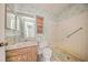 Dilapidated bathroom featuring a toilet, sink, shower, and dated finishes at 7033 Wentworth Way, New Port Richey, FL 34655