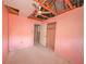Bedroom featuring damaged ceiling, fan, closet, and door at 7033 Wentworth Way, New Port Richey, FL 34655
