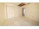 Bedroom featuring closet, doorway, damaged ceiling and walls at 7033 Wentworth Way, New Port Richey, FL 34655