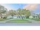 Charming one-story home features a circular driveway and unique stone accents at 7033 Wentworth Way, New Port Richey, FL 34655