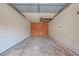Empty garage space showing unfinished walls, concrete floor and a hole in the ceiling at 7033 Wentworth Way, New Port Richey, FL 34655