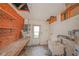 Utility space featuring exposed ceiling, a sink, shelving, and an exterior door at 7033 Wentworth Way, New Port Richey, FL 34655