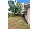 Backyard featuring a wood fence and mature trees providing shade at 72 Lake Shore Dr, Palm Harbor, FL 34684