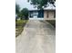 Long driveway leading to a house with a screened-in porch at 72 Lake Shore Dr, Palm Harbor, FL 34684