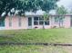 Charming house with a well-maintained front yard and mature landscaping at 72 Lake Shore Dr, Palm Harbor, FL 34684