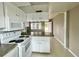 Kitchen featuring white appliances, wood cabinets, and a granite countertop at 72 Lake Shore Dr, Palm Harbor, FL 34684