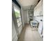Functional laundry room with utility sink, storage cabinets, and access to the backyard at 72 Lake Shore Dr, Palm Harbor, FL 34684