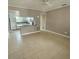 Open-concept living room featuring tile flooring and a breakfast bar at 72 Lake Shore Dr, Palm Harbor, FL 34684